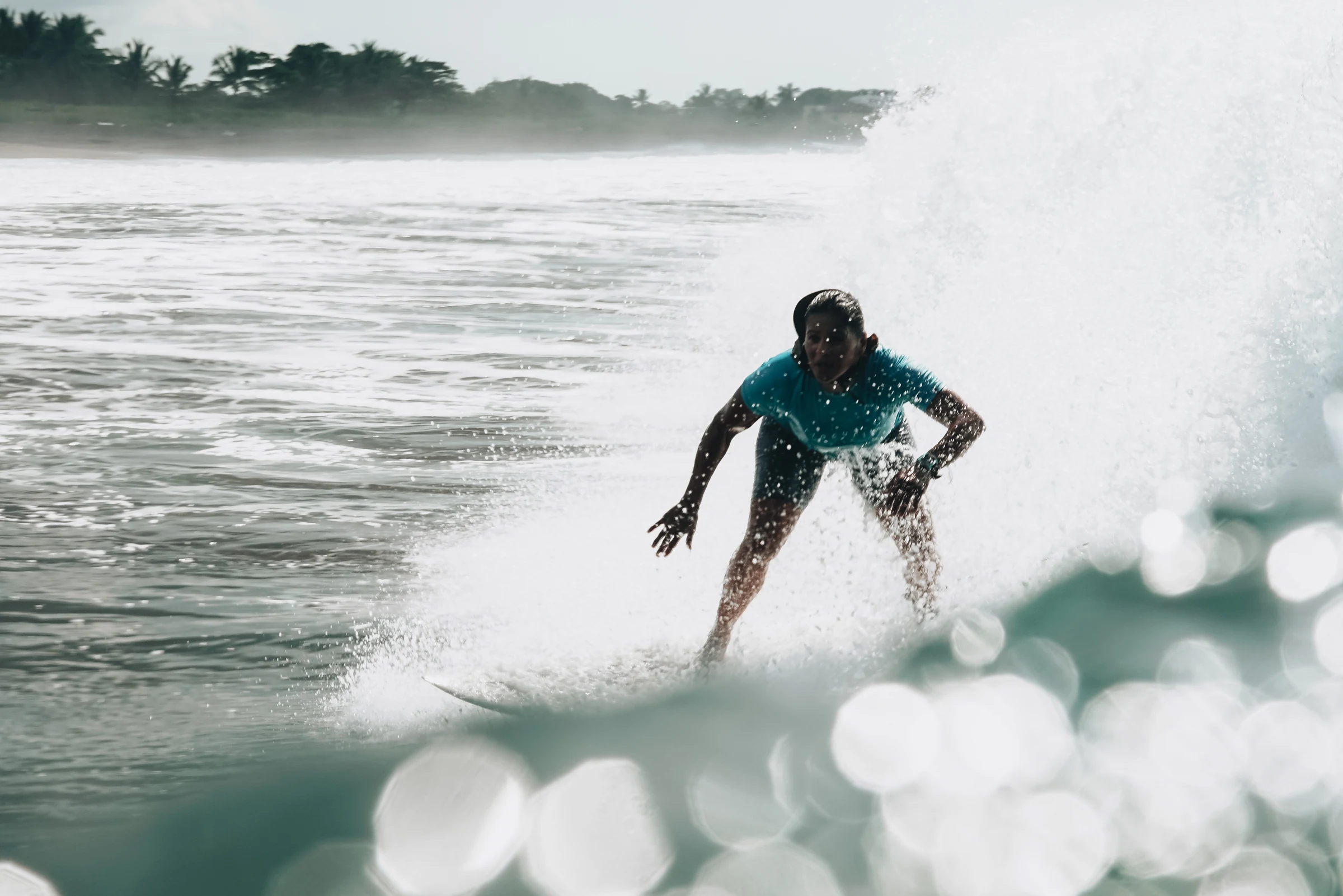 A surfer carving across a wave