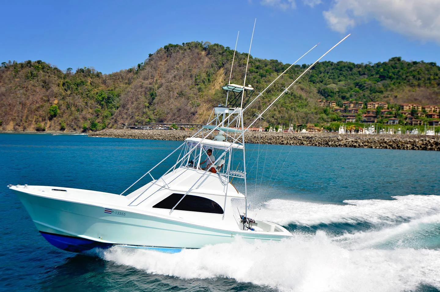 A sportfishing boat running along the coast