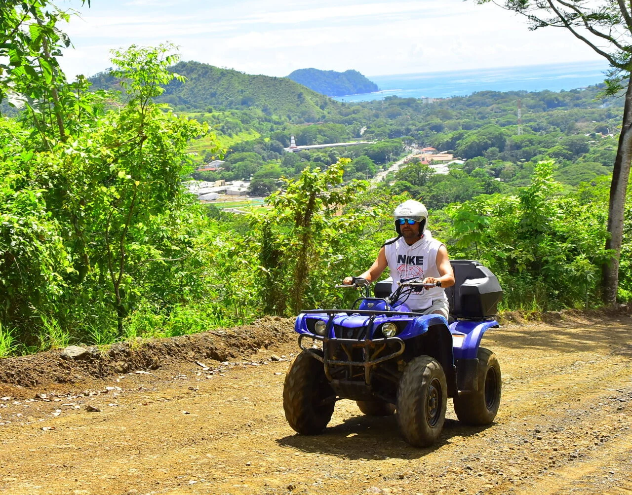 An ATV rider above the Pacific coastline