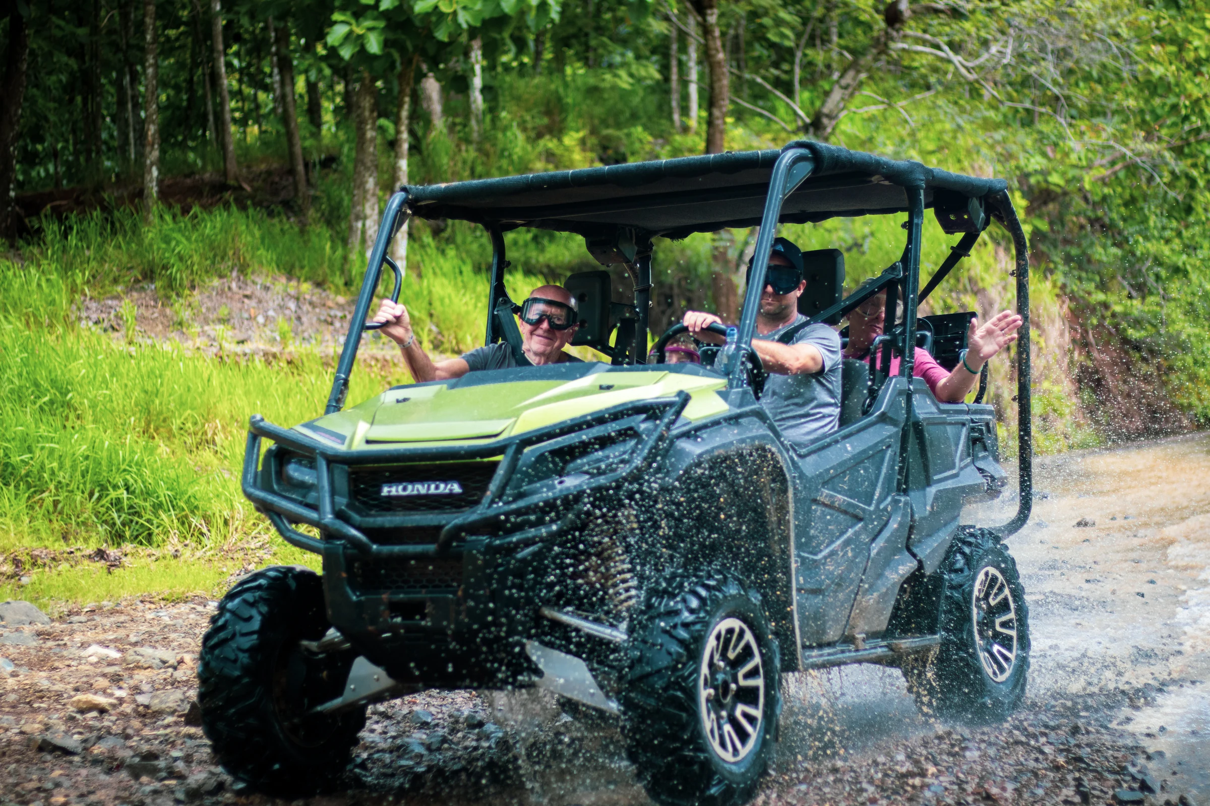 A side-by-side buggy on a jungle trail