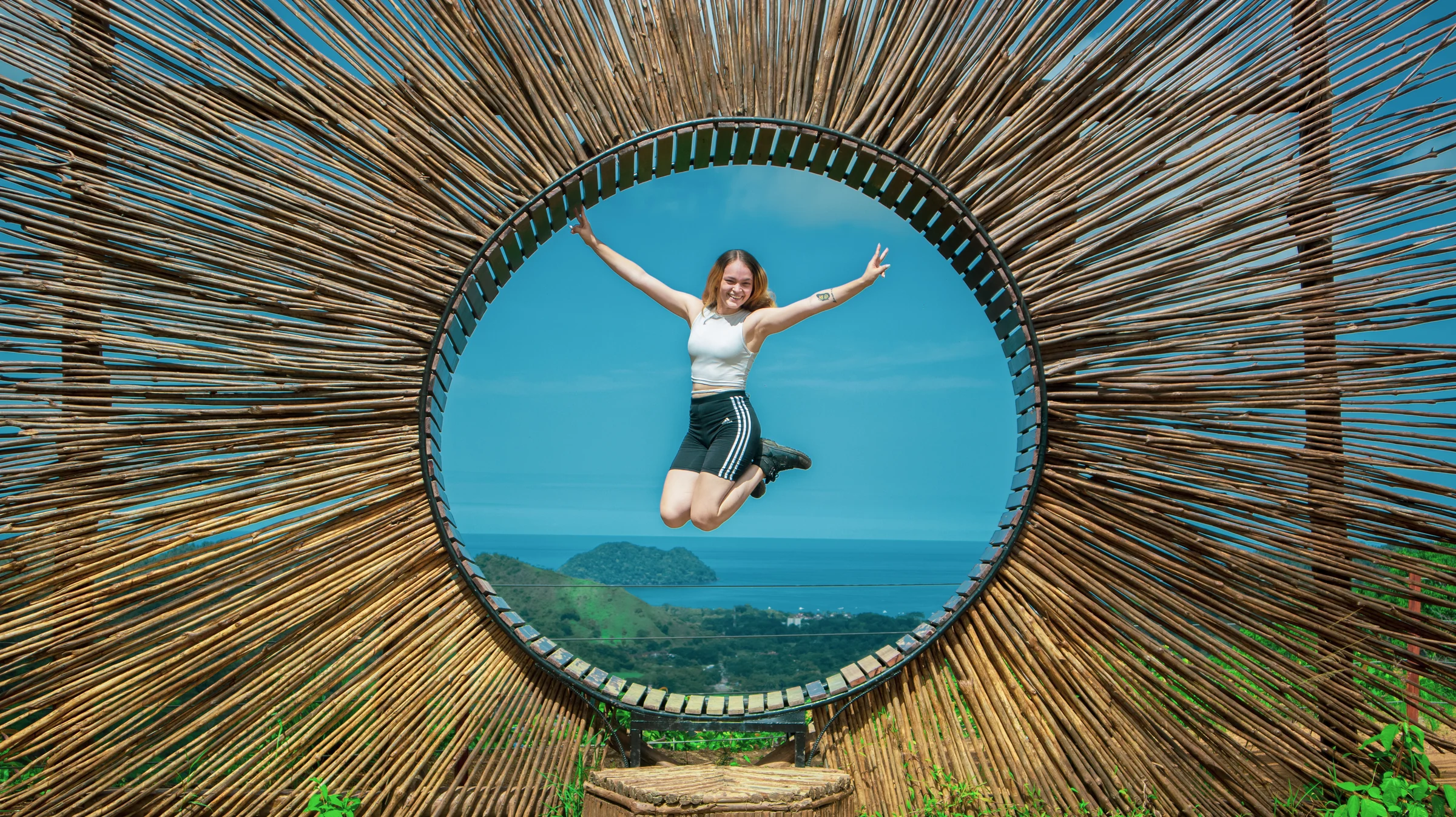 A guest jumping inside a woven lookout frame