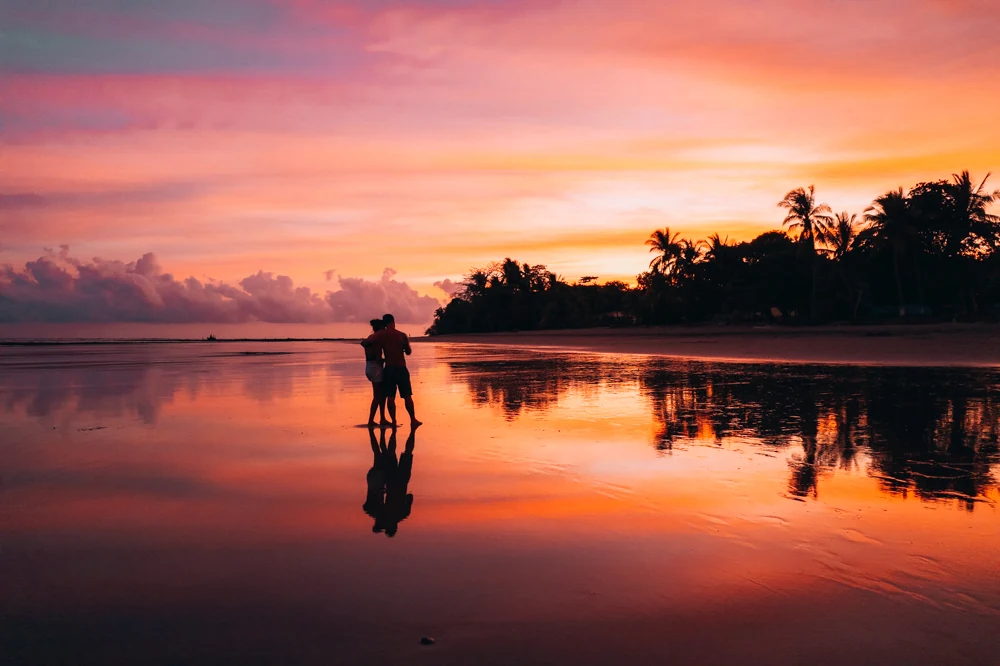 A traveller reflected in the sand at sunset
